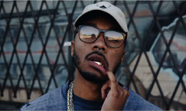 man wearing a hat and glasses pulling his lip down with a dental emergency